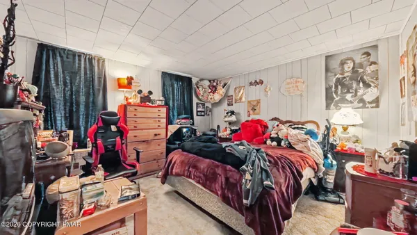 a bedroom with two beds and a closet