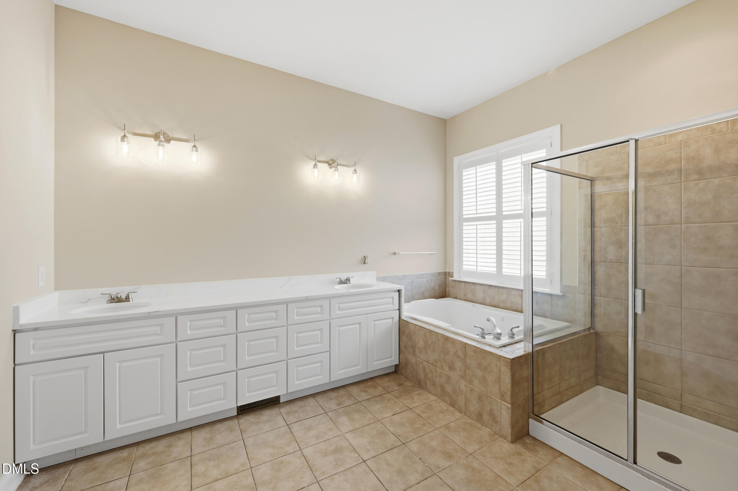 4803 Marena Place Durham, NC 27707 - Photo 15 of 42 a bathroom with a tub sink and mirror