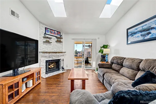 a living room with furniture fireplace and flat screen tv