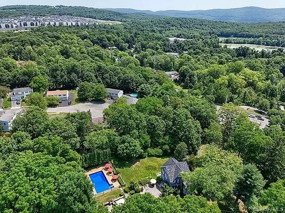 an aerial view of a house with a yard