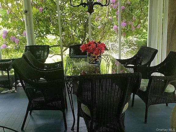 a view of backyard with seating space and trees