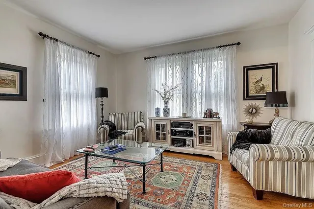 a view of a bedroom with wooden floor