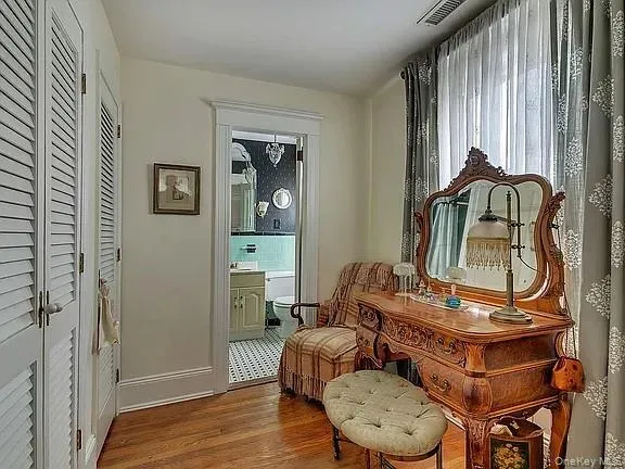 a bedroom with a bed and a mirror