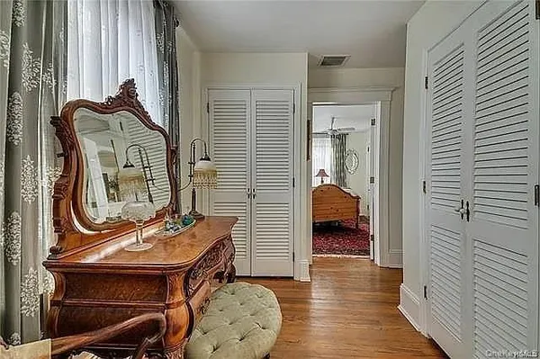 a bedroom with a bed couch and a window