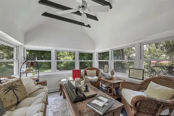 a living room with a bed furniture and a large window