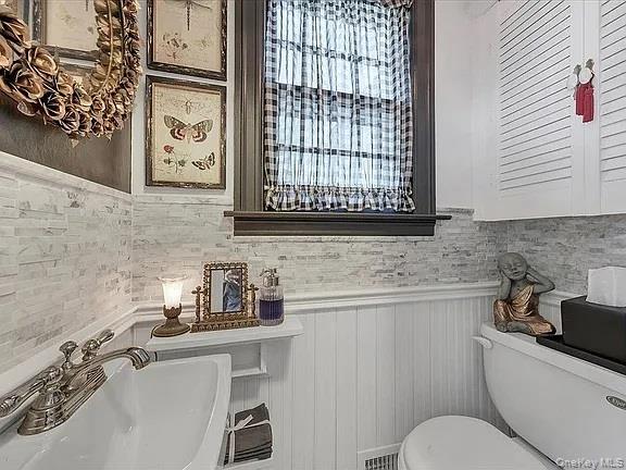 421 Spring Street Monroe, NY 10950 - Photo 42 of 49 a bathroom with a sink a toilet and mirror