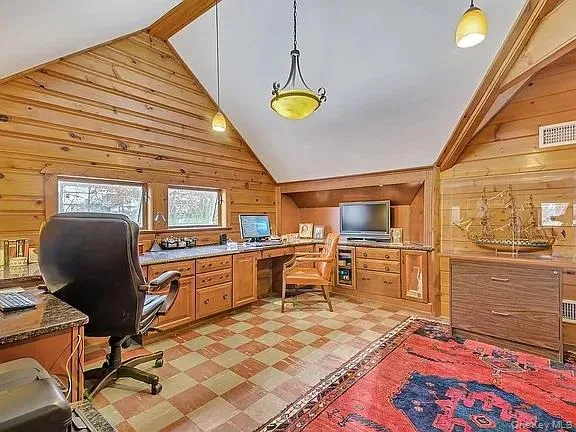 a room with lots of furniture and a ceiling fan