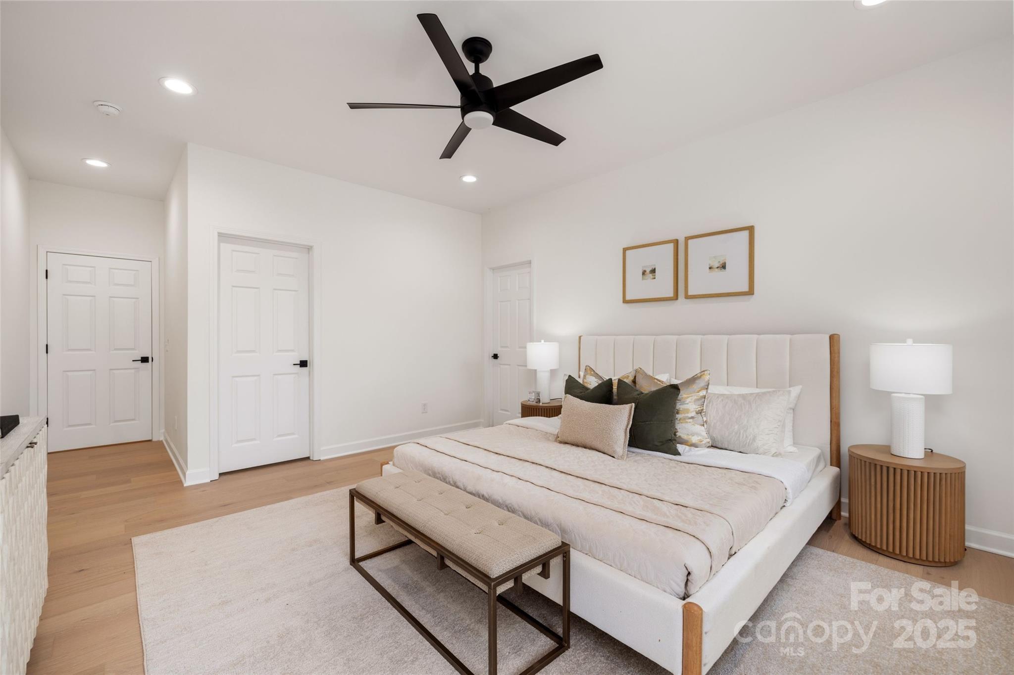 15906 Youngblood Road Charlotte, NC 28278 - Photo 13 of 41 a bedroom with a bed and a ceiling fan
