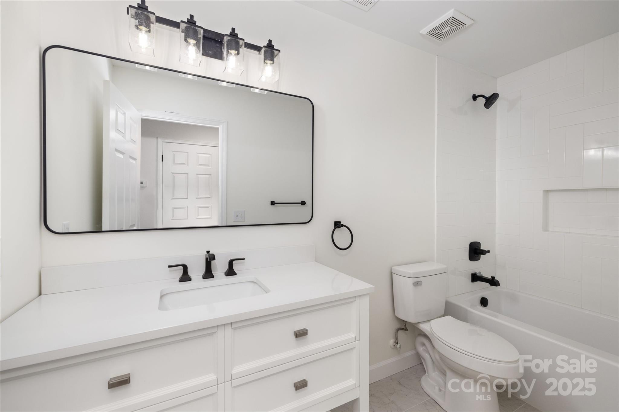 15906 Youngblood Road Charlotte, NC 28278 - Photo 23 of 41 a bathroom with a granite countertop toilet sink and a mirror