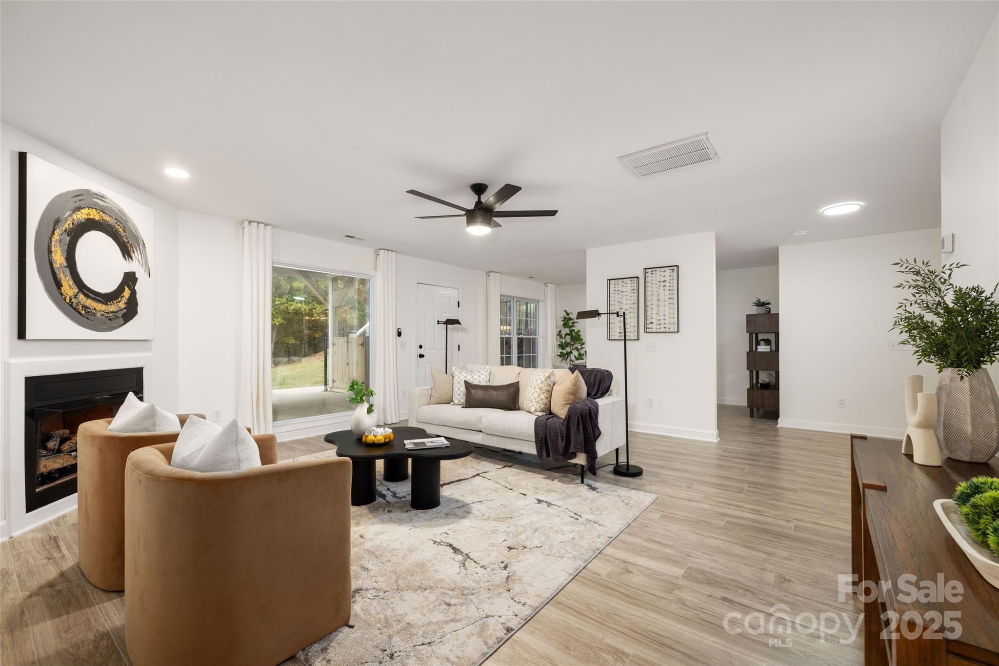 15906 Youngblood Road Charlotte, NC 28278 - Photo 24 of 41 a living room with furniture a fireplace and a potted plant