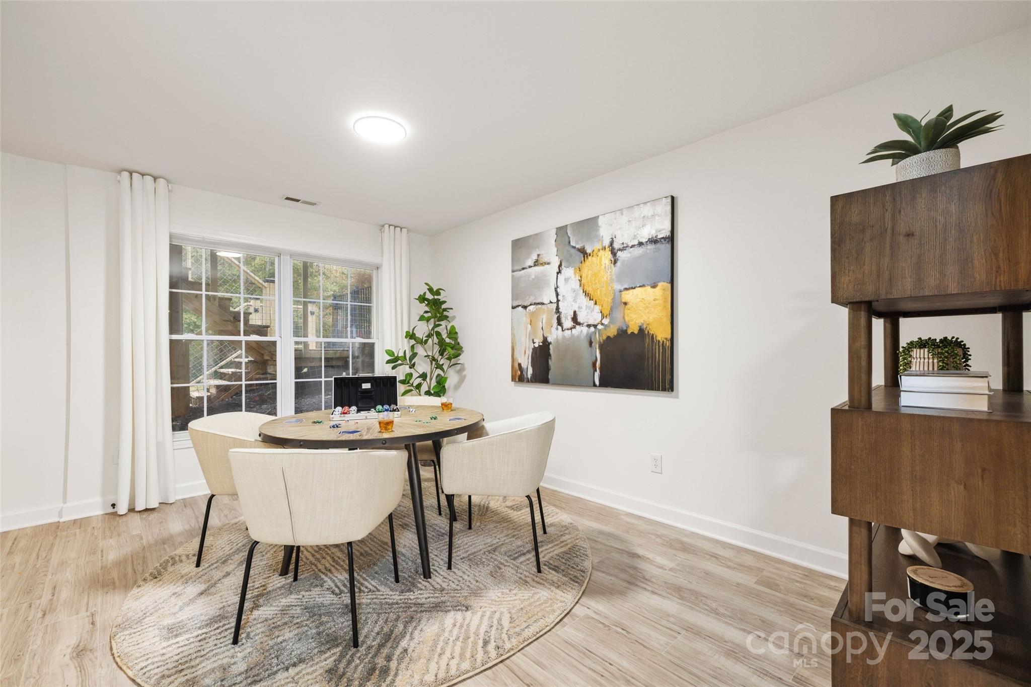15906 Youngblood Road Charlotte, NC 28278 - Photo 27 of 41 a view of a dining room with furniture window and wooden floor