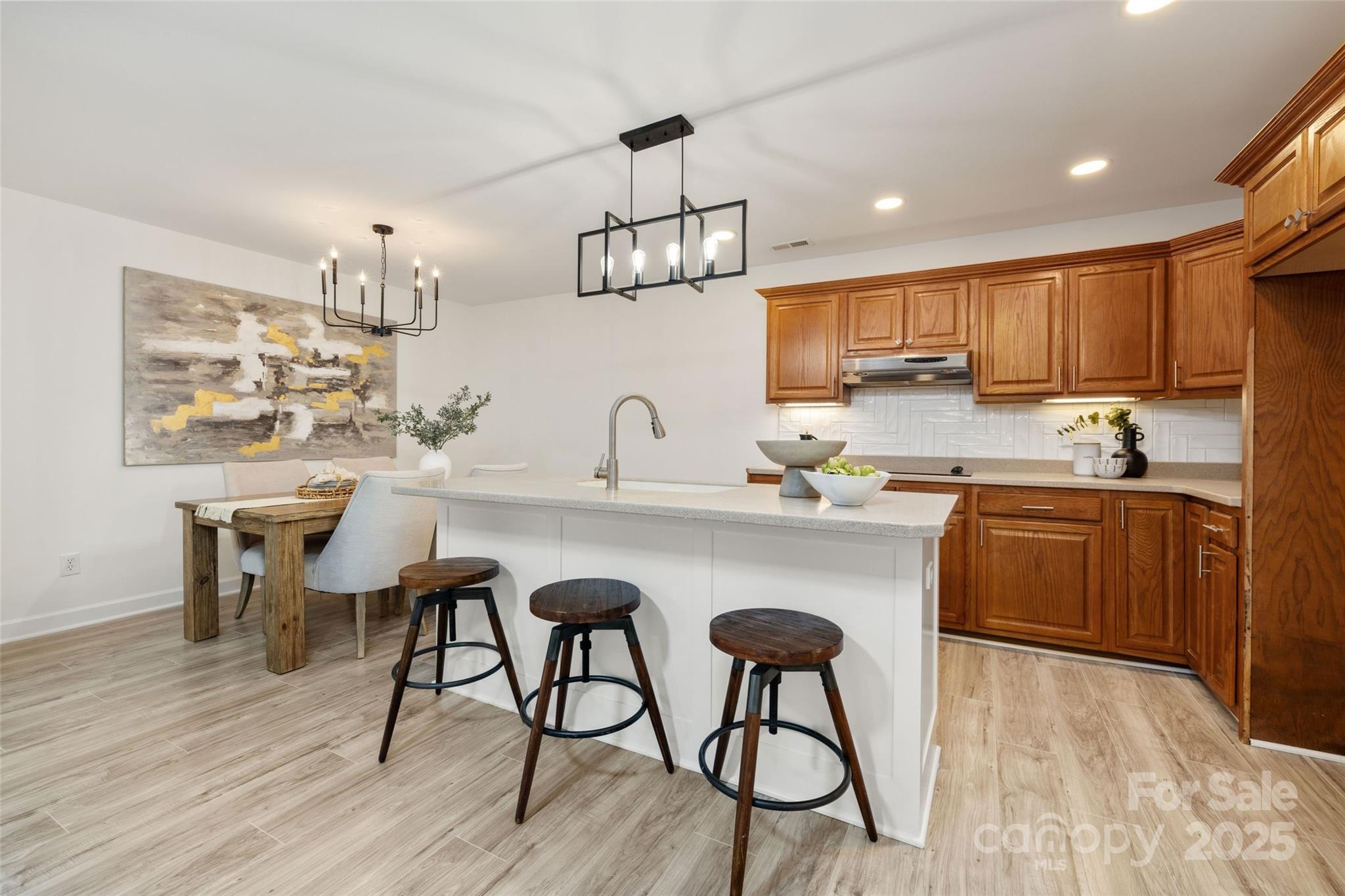 15906 Youngblood Road Charlotte, NC 28278 - Photo 30 of 41 a kitchen with a table chairs microwave and cabinets