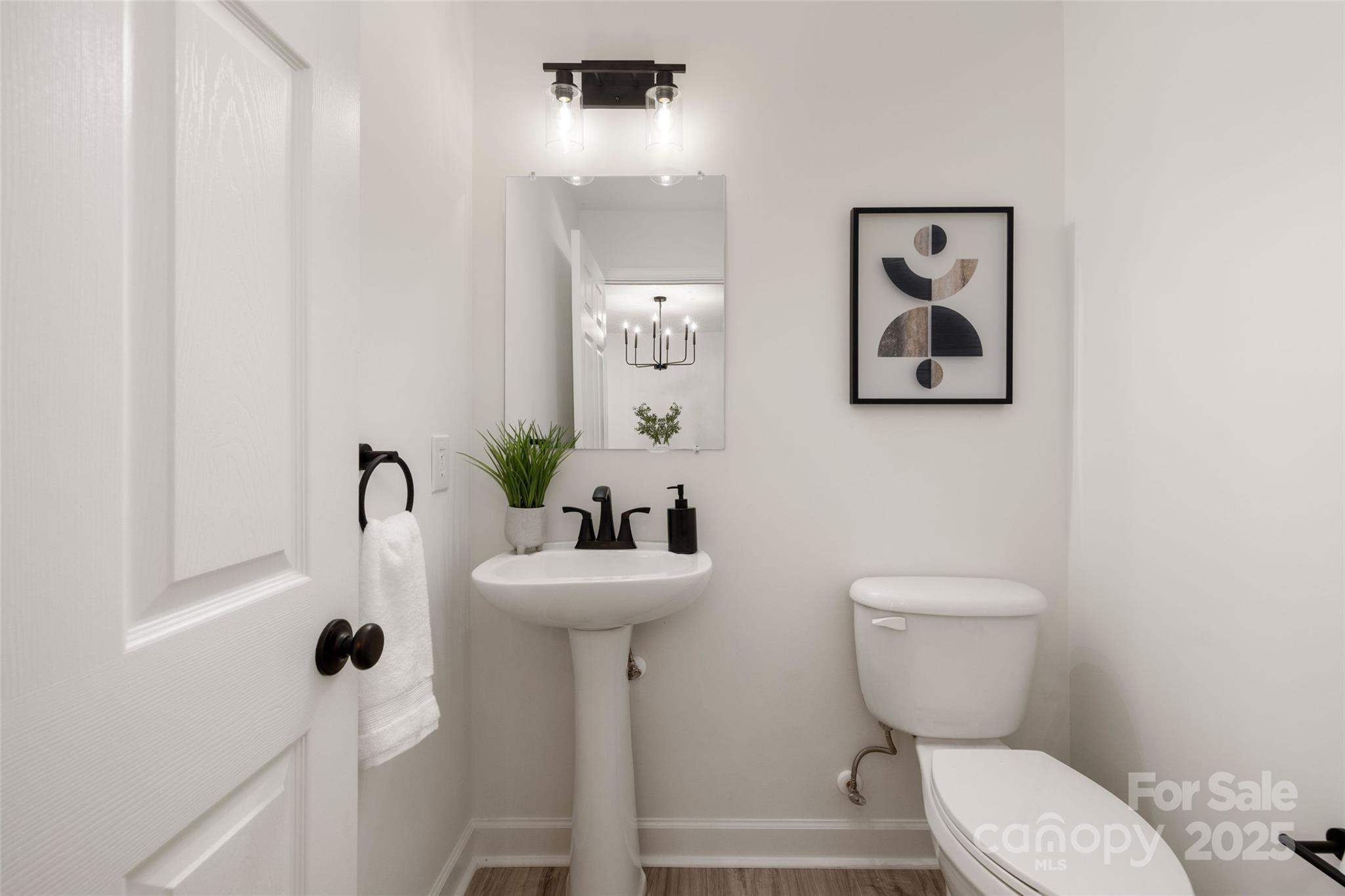 15906 Youngblood Road Charlotte, NC 28278 - Photo 31 of 41 a bathroom with a toilet sink and mirror