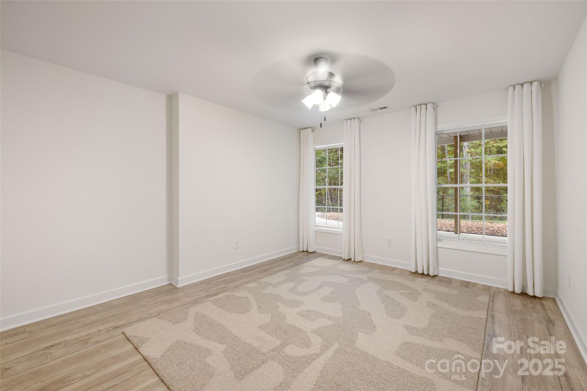 15906 Youngblood Road Charlotte, NC 28278 - Photo 32 of 41 an empty room with chandelier fan and windows