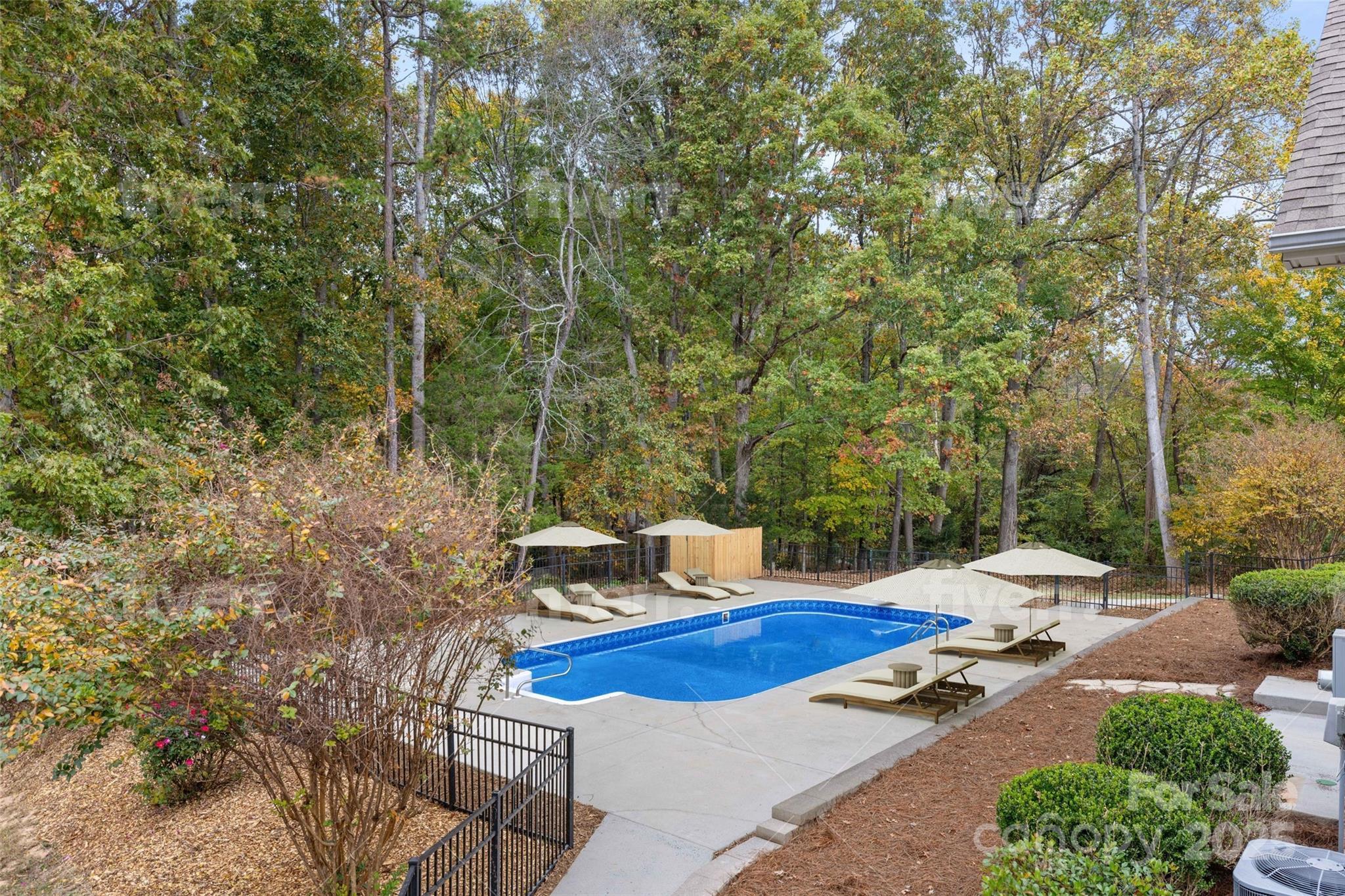 15906 Youngblood Road Charlotte, NC 28278 - Photo 40 of 41 a patio with table and chairs and potted plants