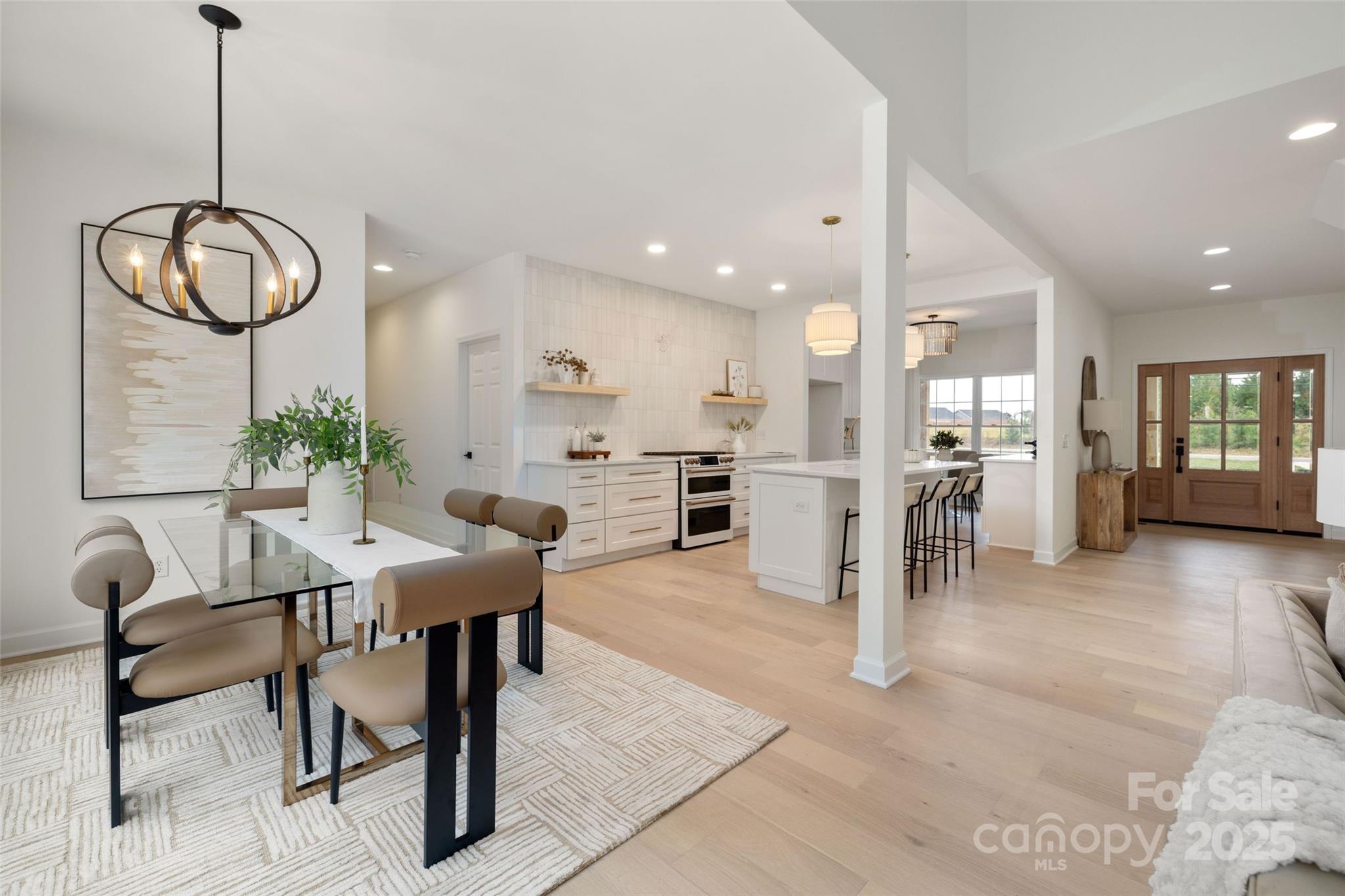 15906 Youngblood Road Charlotte, NC 28278 - Photo 5 of 41 a view of a dining room and livingroom with furniture wooden floor a chandelier