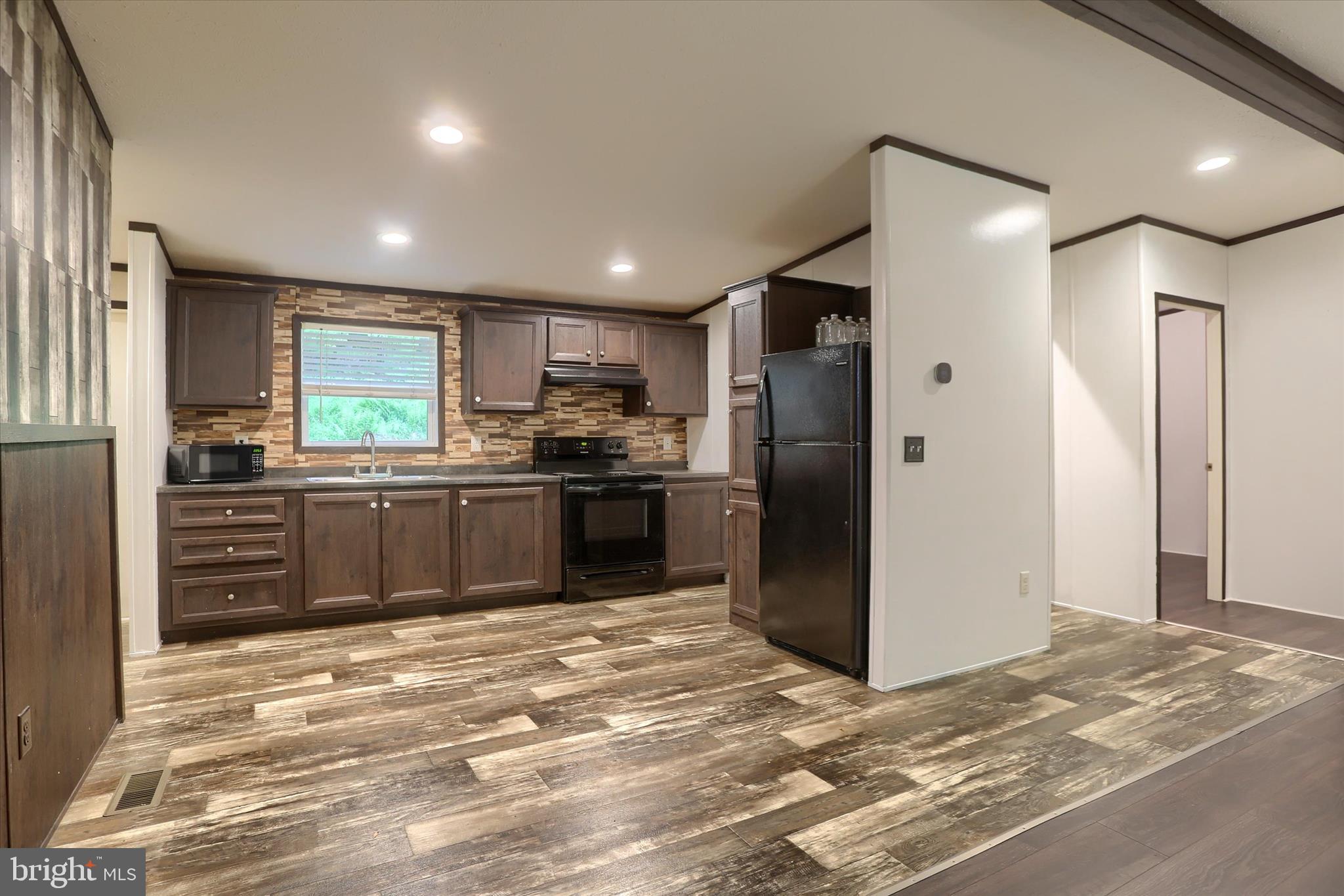 1148 Moulstown Road North Hanover, PA 17331 - Photo 8 of 29 a kitchen with stainless steel appliances kitchen island granite countertop a refrigerator and a sink