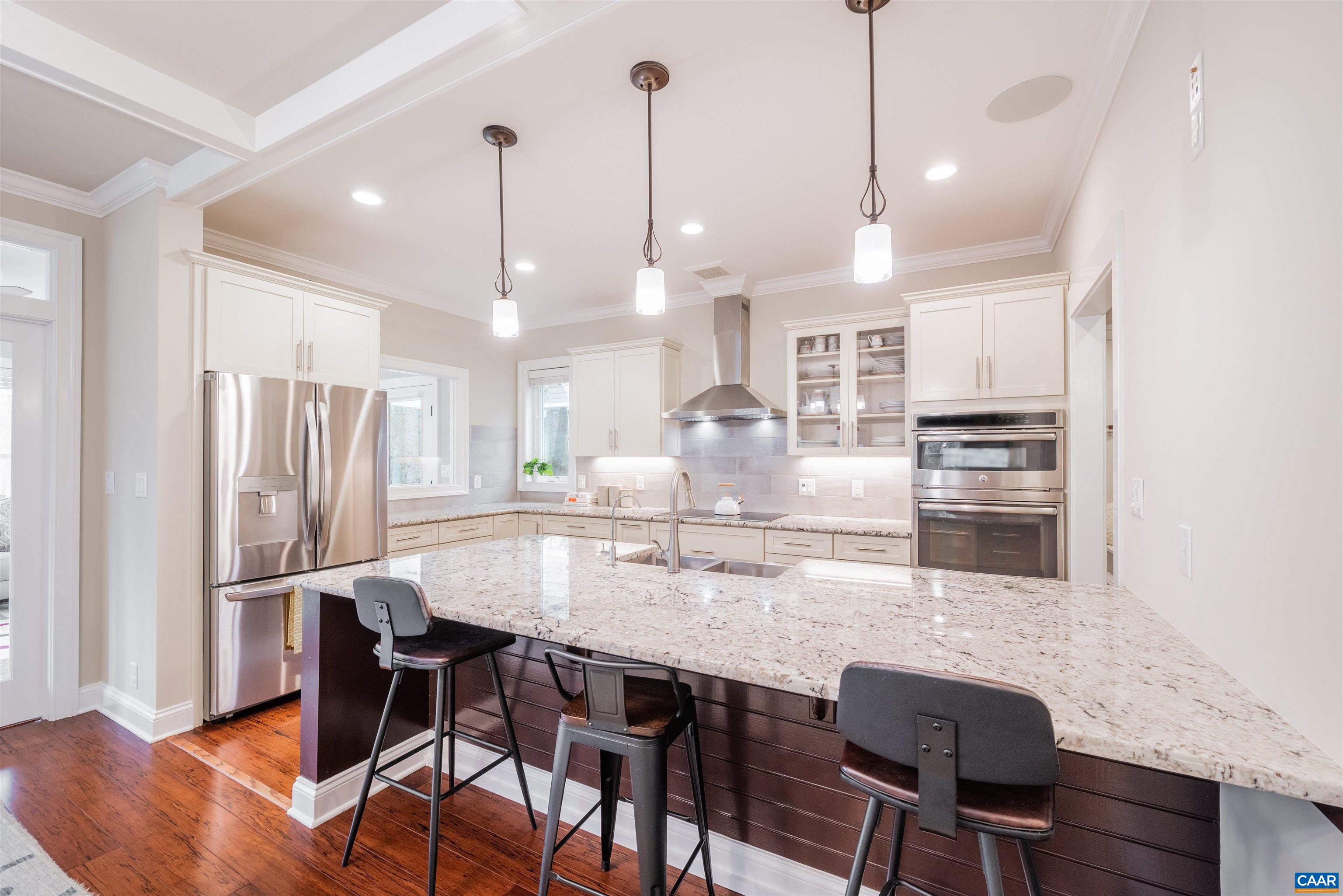303 Turkey Ridge Road Charlottesville, VA 22903 - Photo 11 of 49 a kitchen with stainless steel appliances granite countertop a dining table chairs refrigerator and microwave