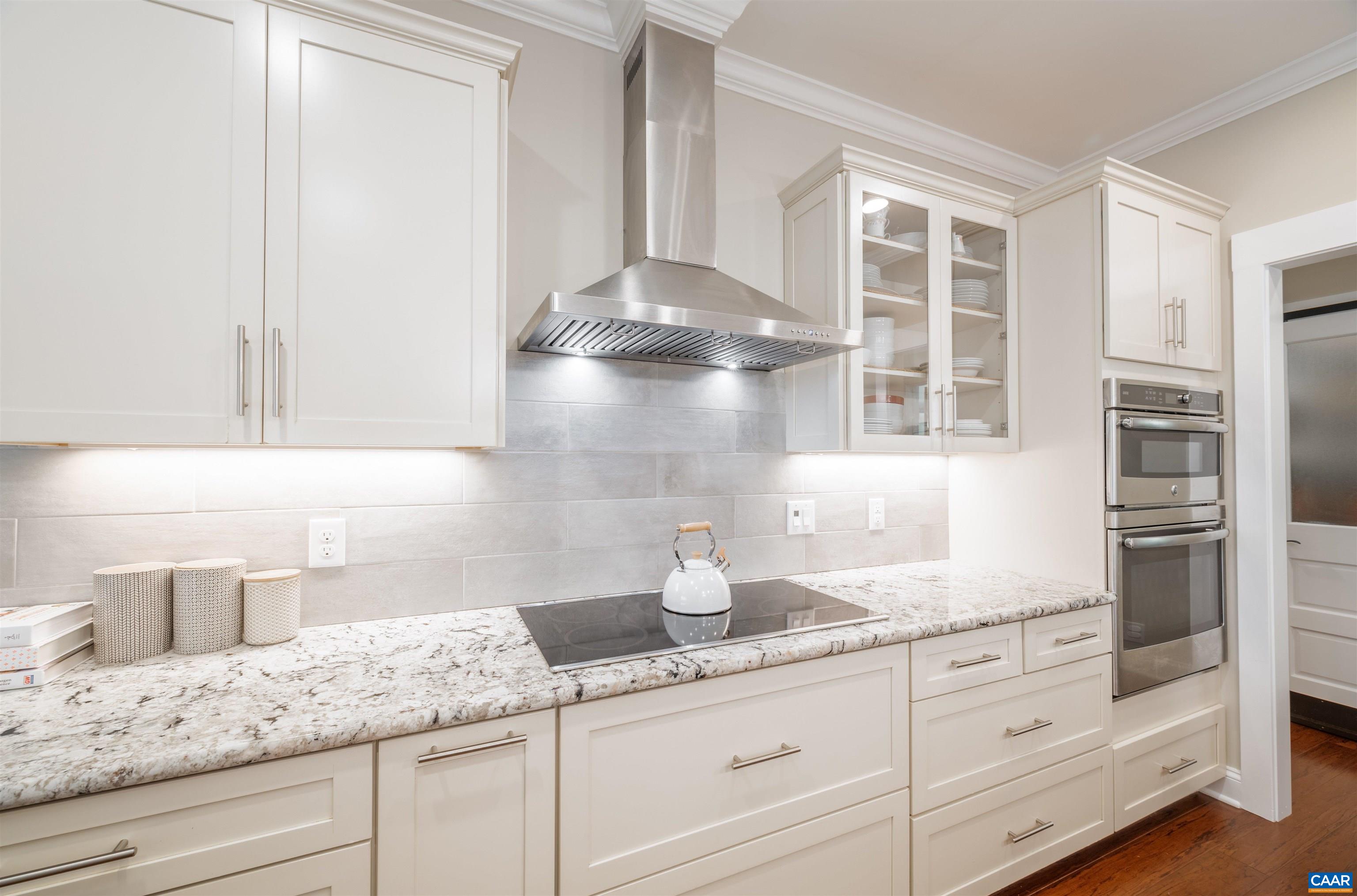303 Turkey Ridge Road Charlottesville, VA 22903 - Photo 12 of 49 a kitchen with granite countertop white cabinets and stainless steel appliances
