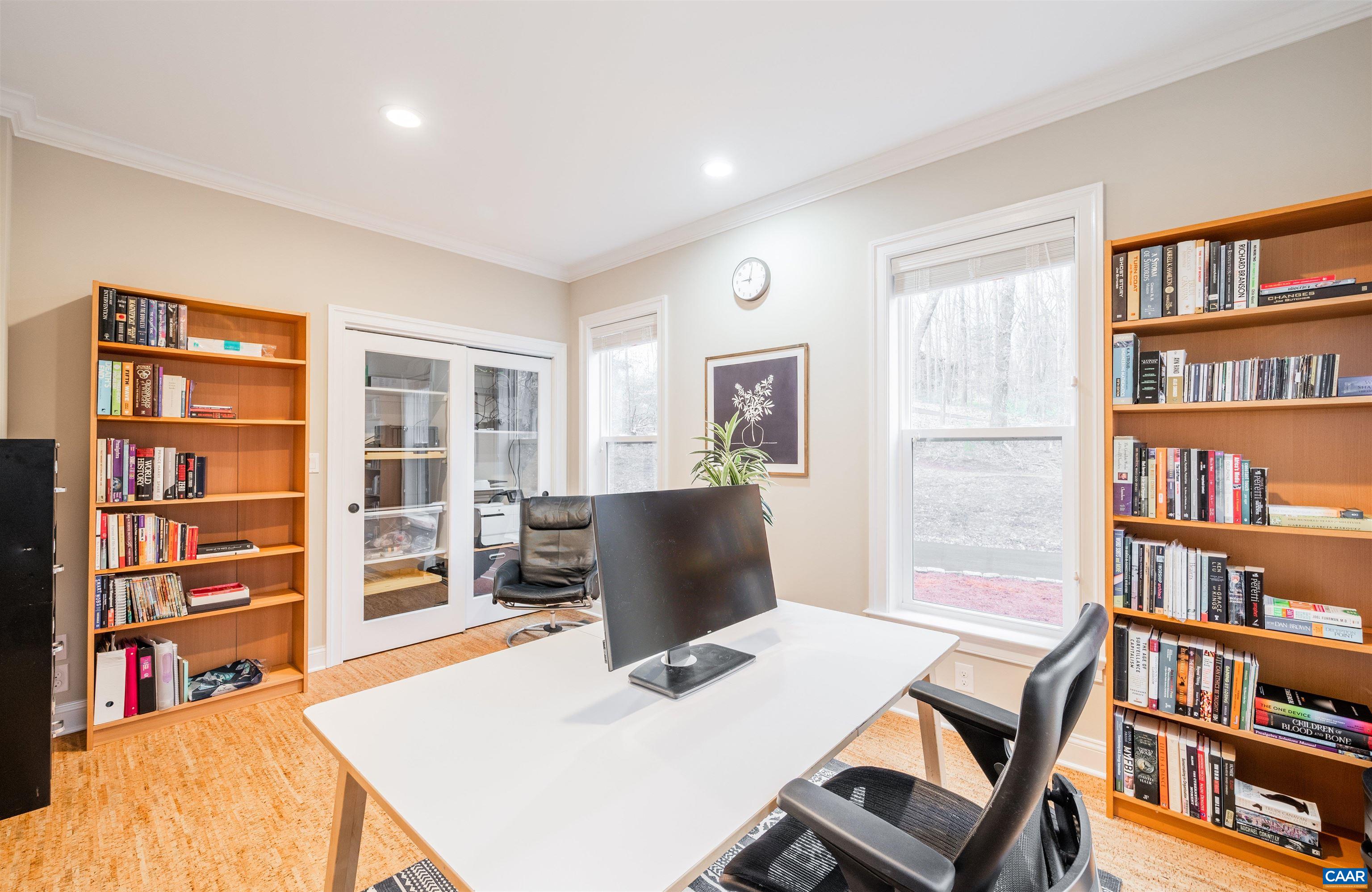 303 Turkey Ridge Road Charlottesville, VA 22903 - Photo 20 of 49 a view of a workspace with furniture and a book shelf