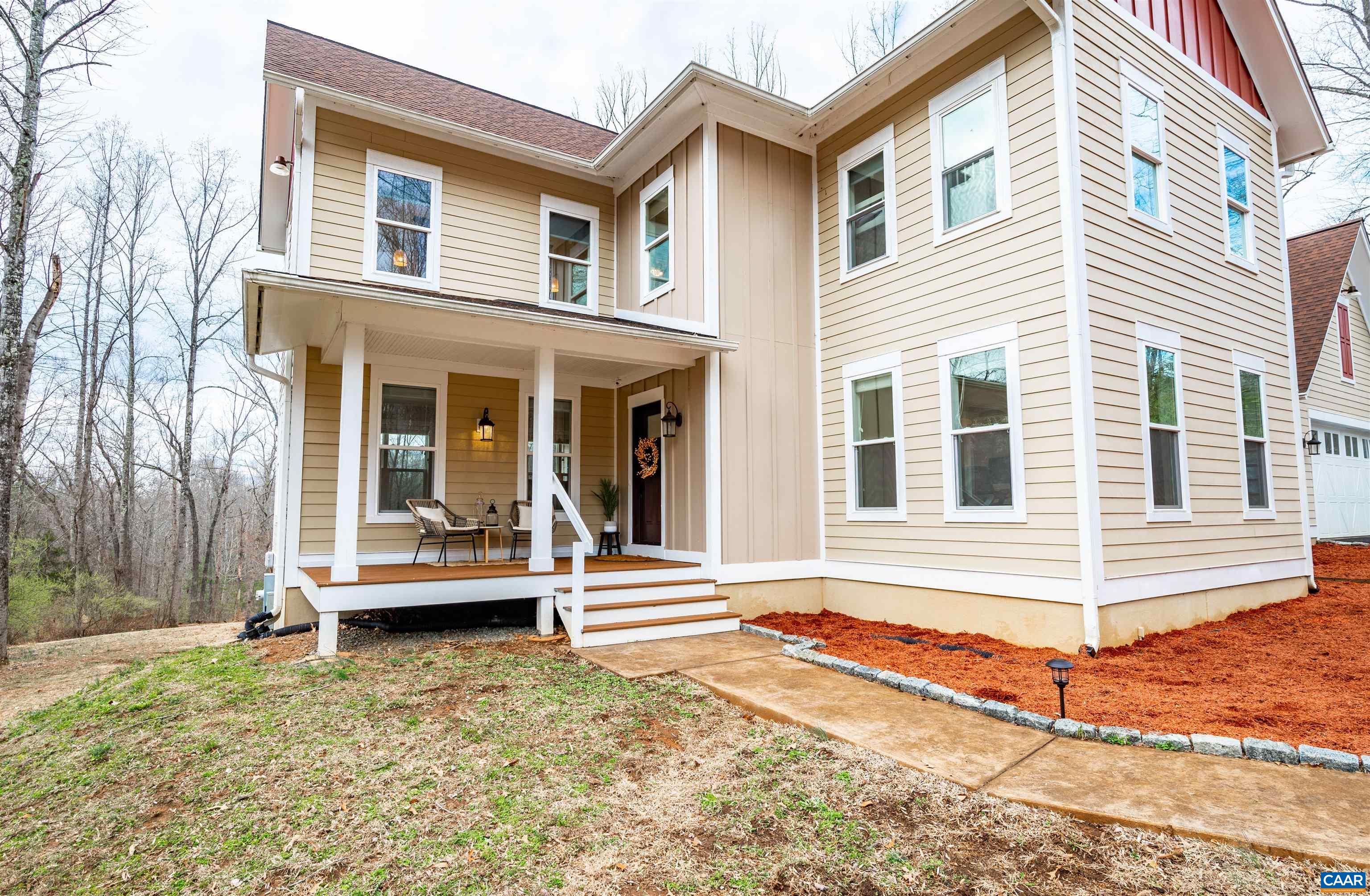 303 Turkey Ridge Road Charlottesville, VA 22903 - Photo 2 of 49 a view of a white house with a large windows and a yard