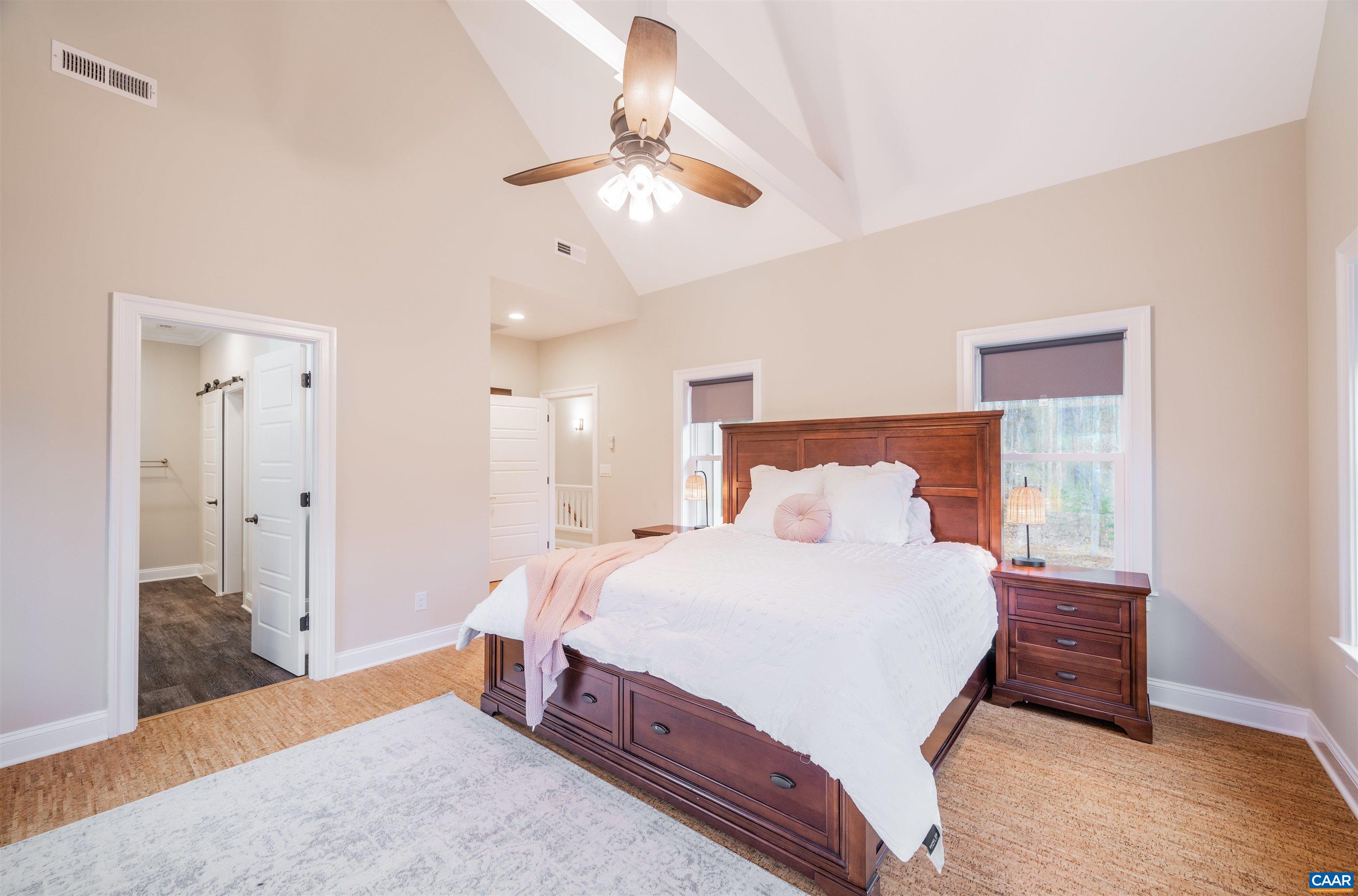 303 Turkey Ridge Road Charlottesville, VA 22903 - Photo 25 of 49 a bedroom with a bed and a chandelier