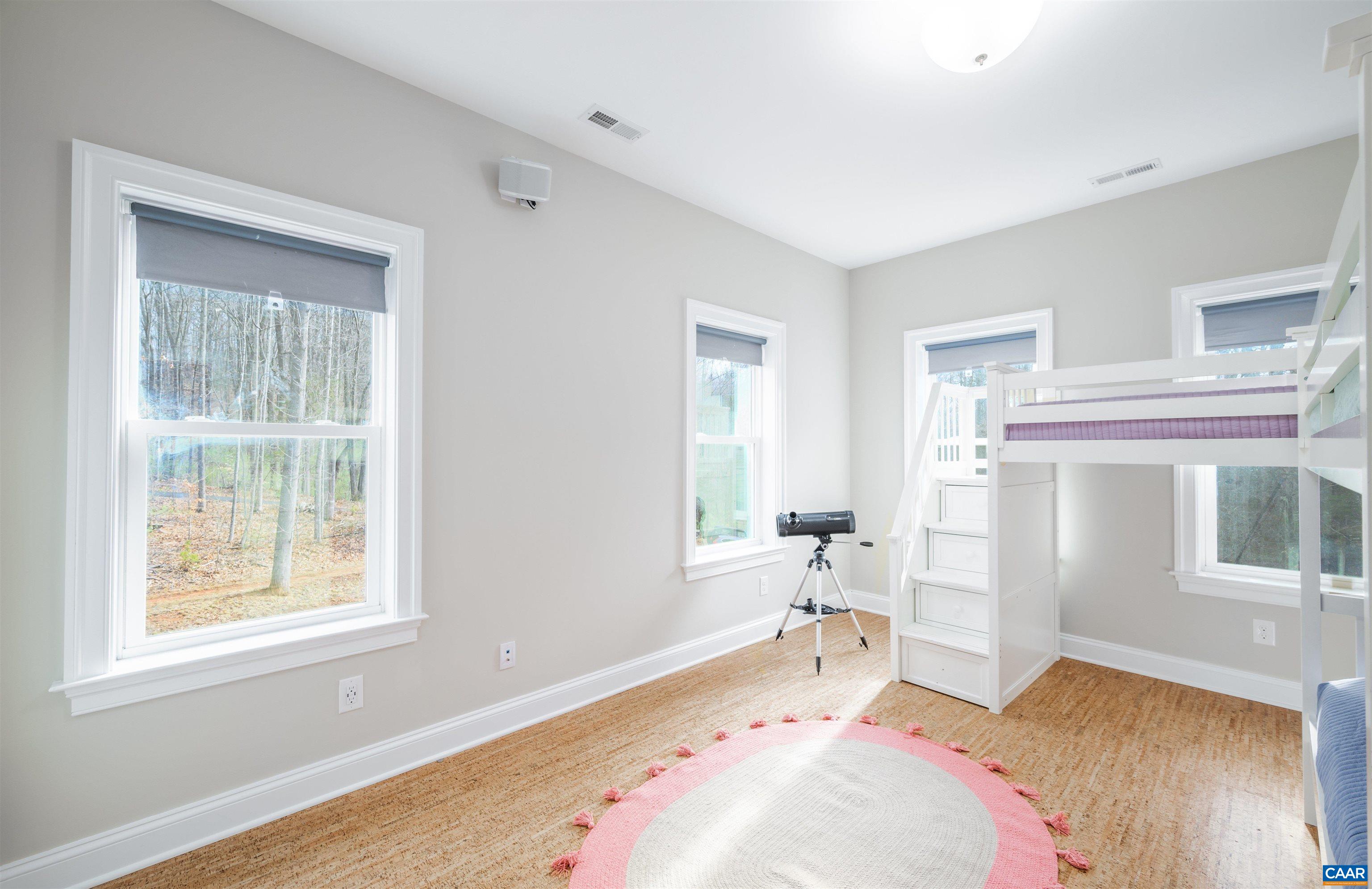 303 Turkey Ridge Road Charlottesville, VA 22903 - Photo 31 of 49 a bedroom with a bed and wooden floor