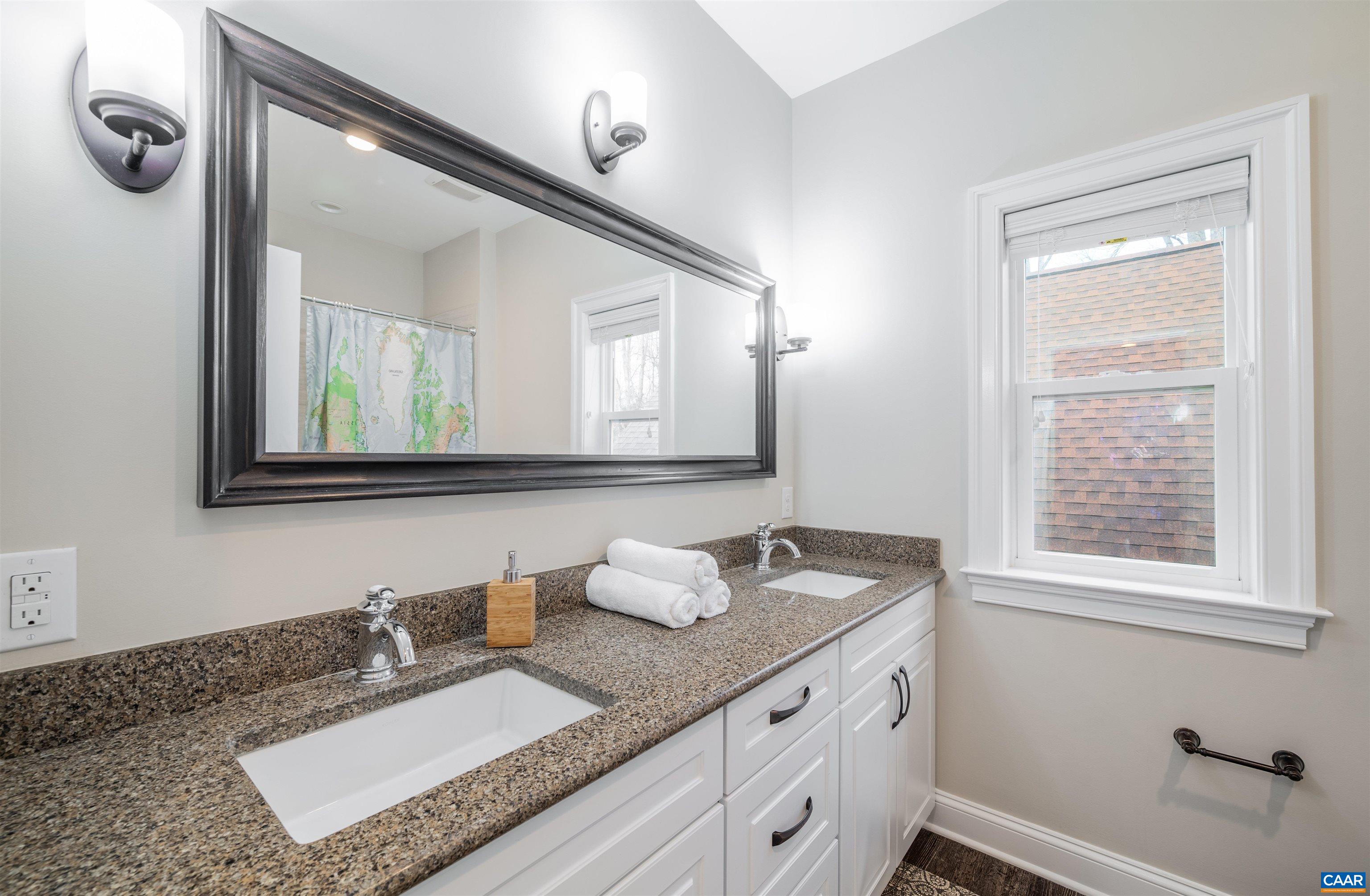 303 Turkey Ridge Road Charlottesville, VA 22903 - Photo 33 of 49 a bathroom with a granite countertop sink and a mirror