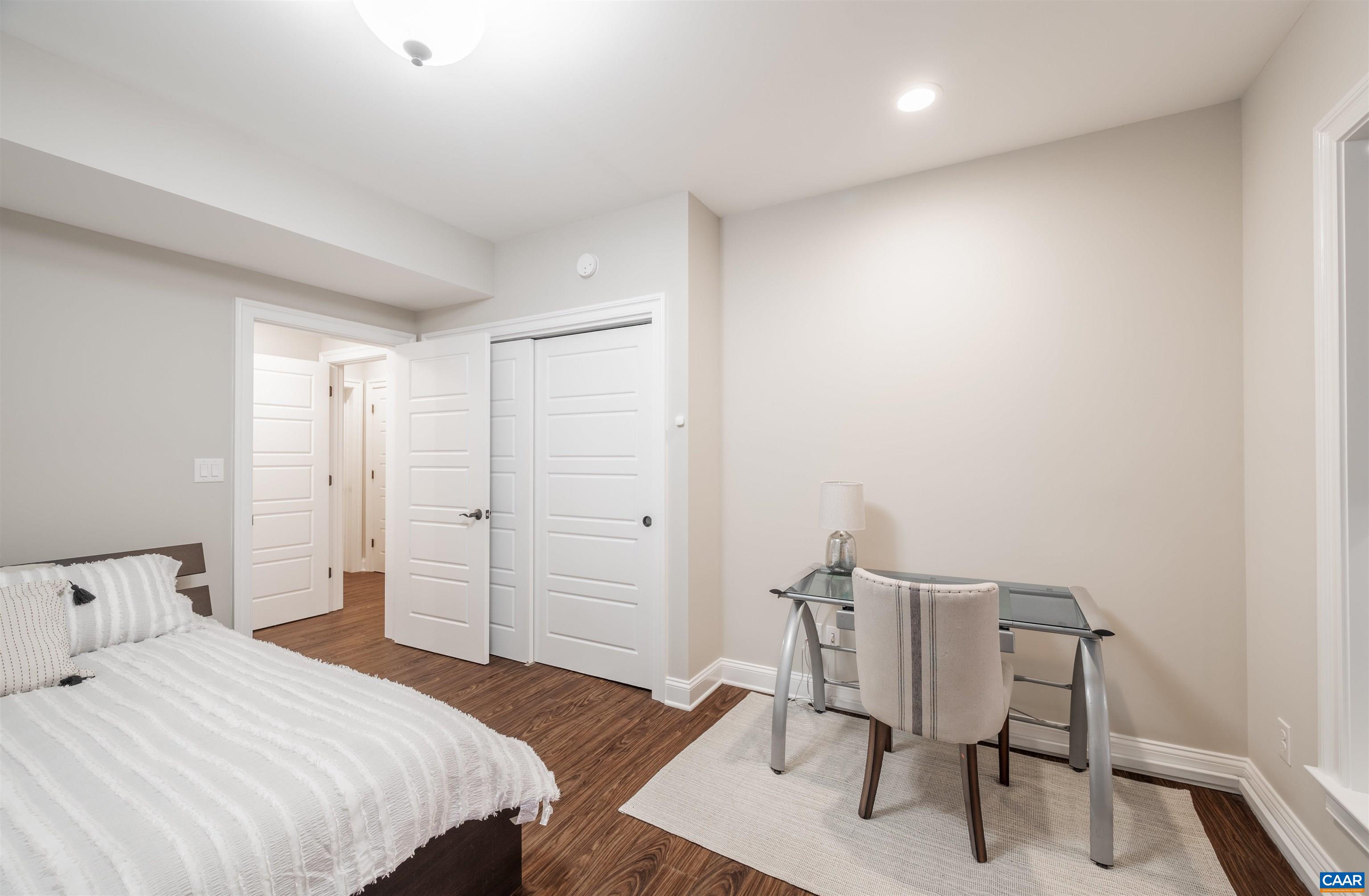 303 Turkey Ridge Road Charlottesville, VA 22903 - Photo 38 of 49 a bedroom with a bed and a chair