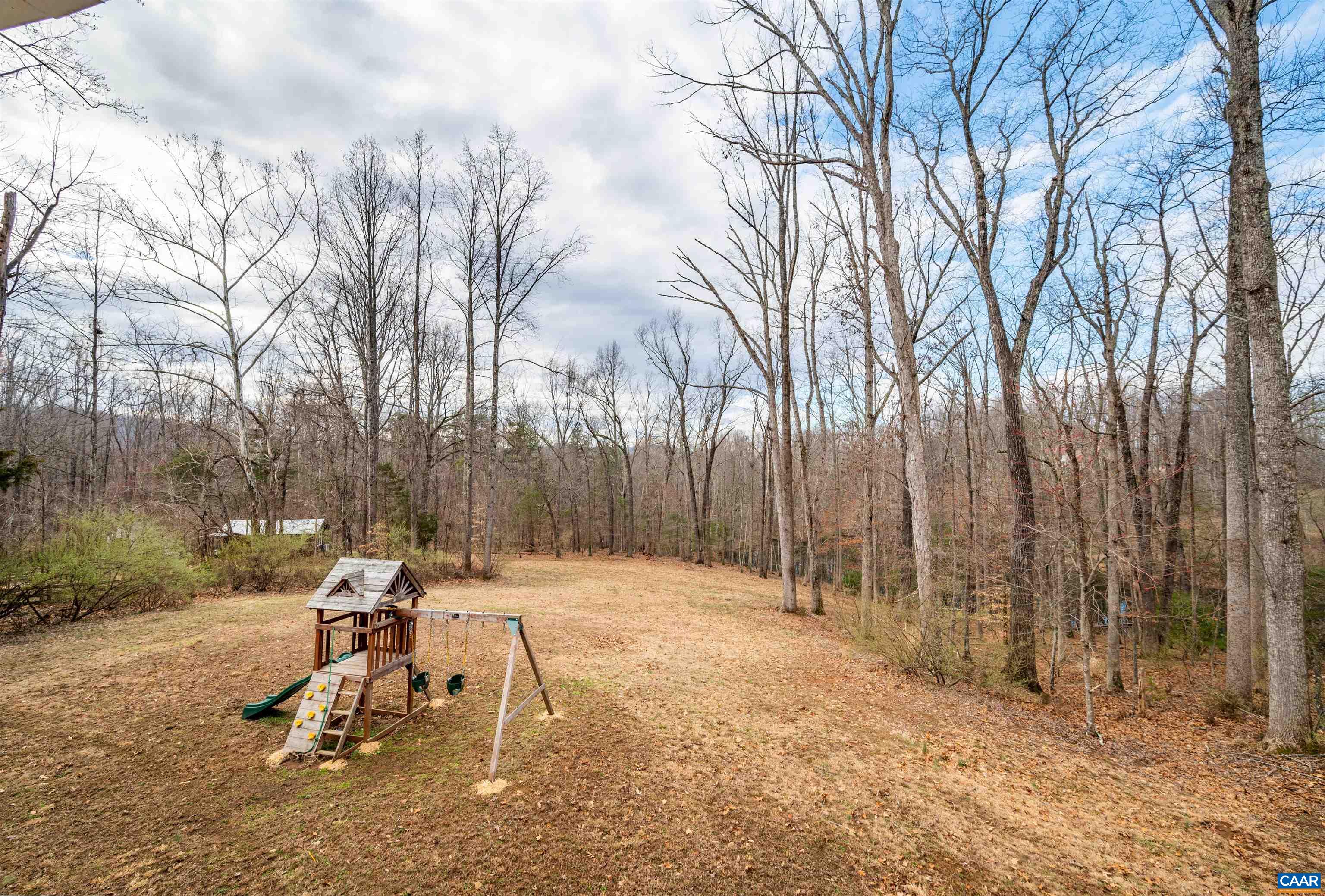 303 Turkey Ridge Road Charlottesville, VA 22903 - Photo 46 of 49 a backyard of a house with table and chairs