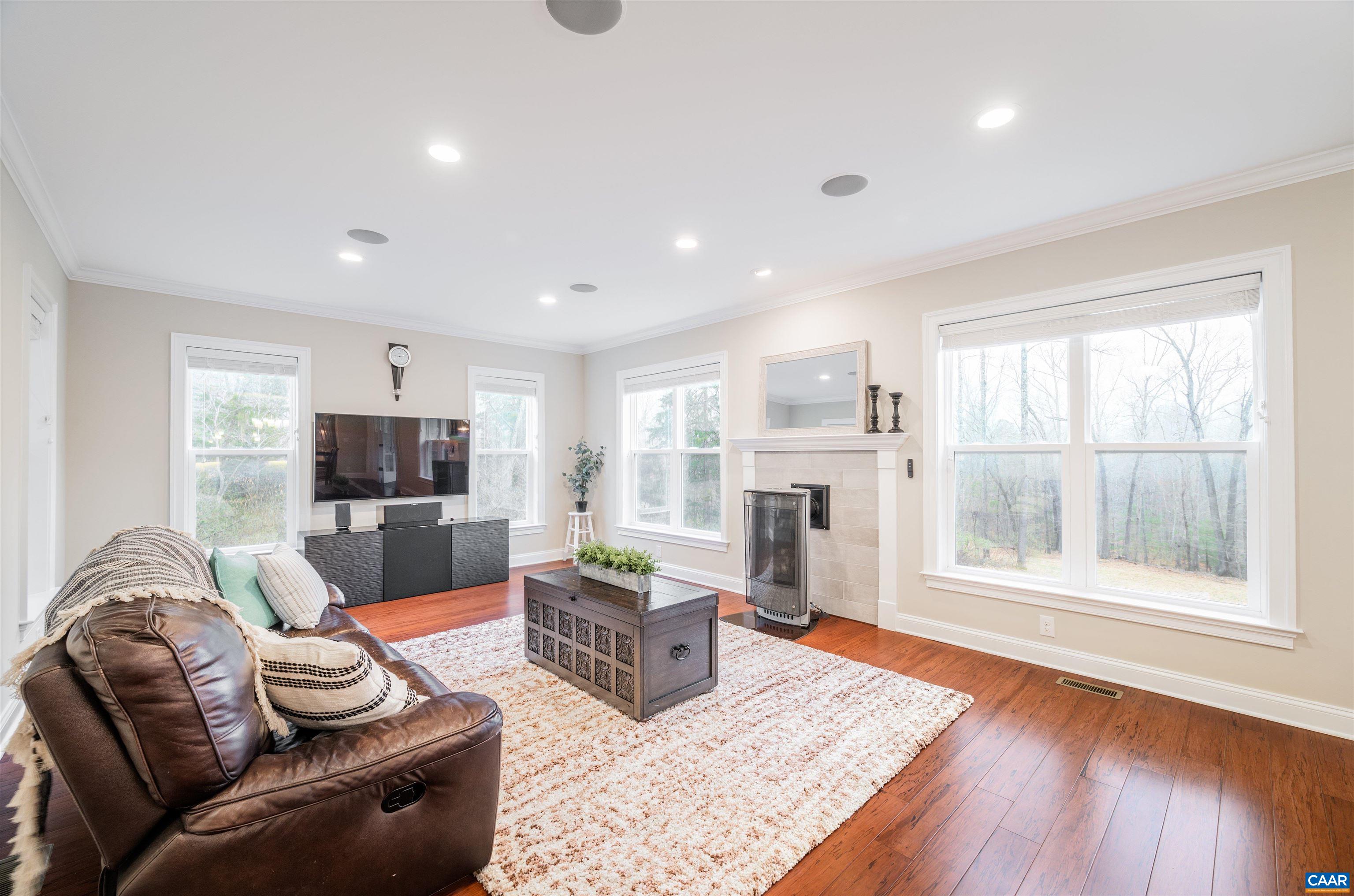303 Turkey Ridge Road Charlottesville, VA 22903 - Photo 6 of 49 a living room with furniture wooden floor and a fireplace