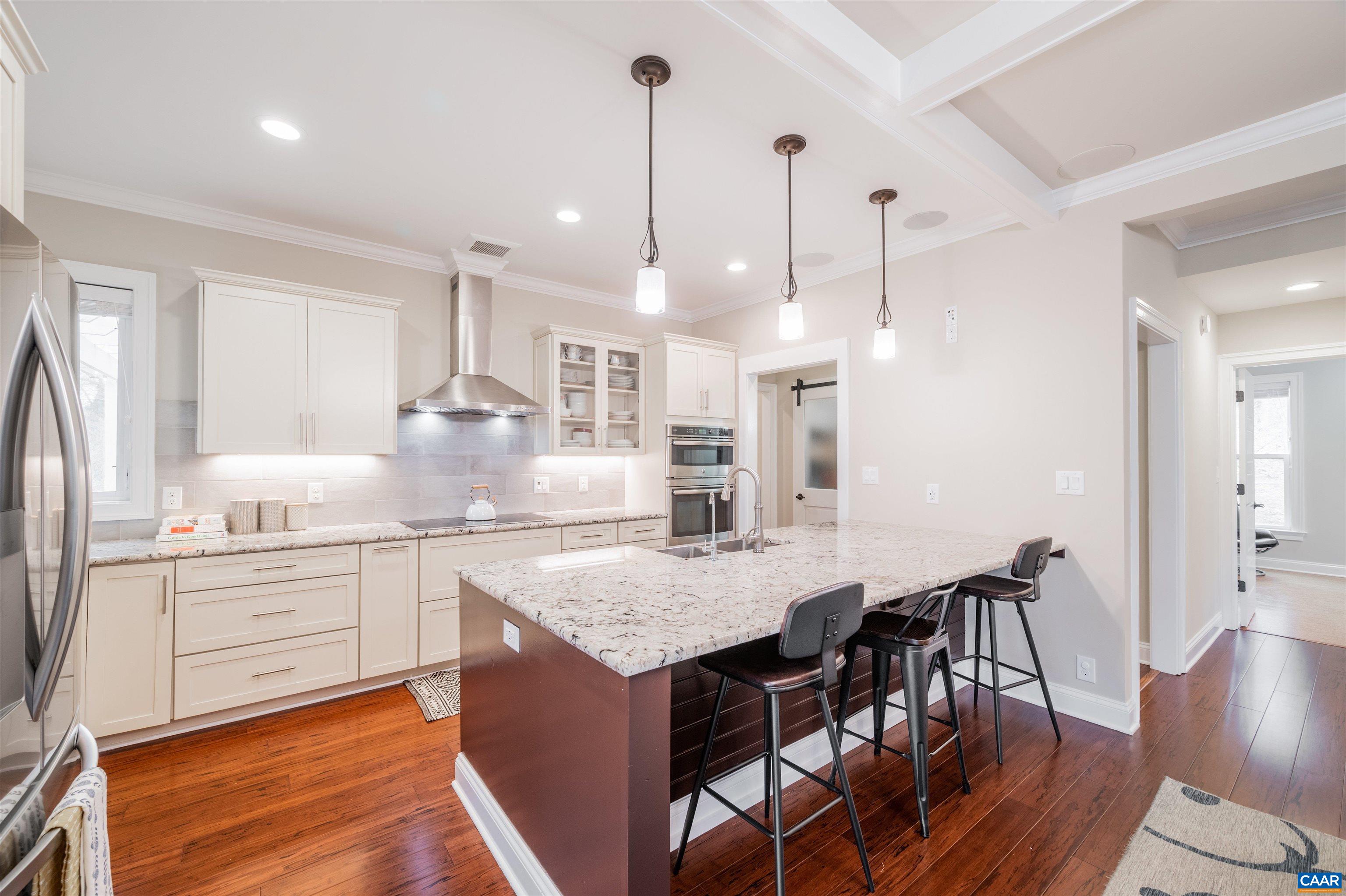 303 Turkey Ridge Road Charlottesville, VA 22903 - Photo 10 of 49 a kitchen with stainless steel appliances granite countertop a kitchen island a stove a table and chairs in it