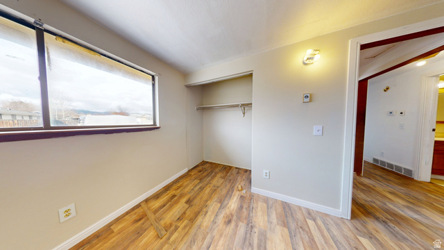 1348 Sagewood Road Price, UT 84501 - Photo 17 of 34 Unfurnished bedroom with light wood-type flooring and a closet