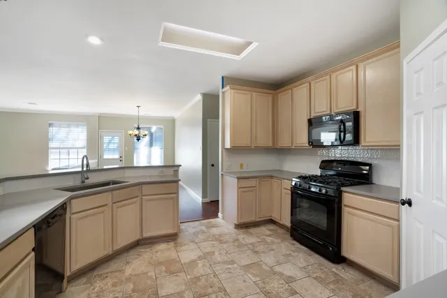 a kitchen with a refrigerator sink and stove
