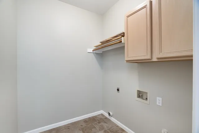 a kitchen with white cabinets and black appliances