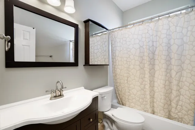 wooden floor in an empty room with chandelier fan