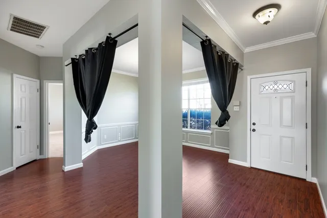 wooden floor in an empty room with a window and wooden floor
