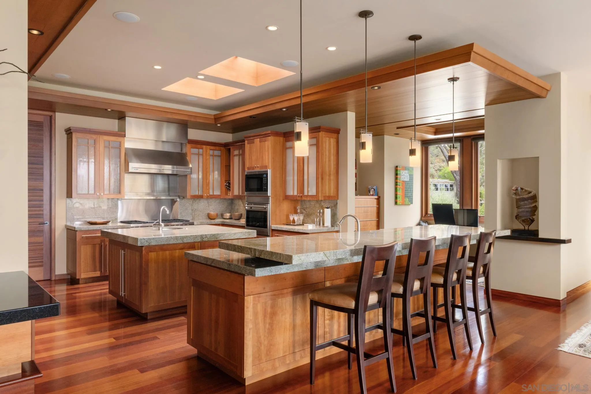 456 Hidden Pines Lane Del Mar, CA 92014 - Photo 11 of 55 a kitchen with stainless steel appliances granite countertop a stove top oven a sink dishwasher and white cabinets with wooden floor