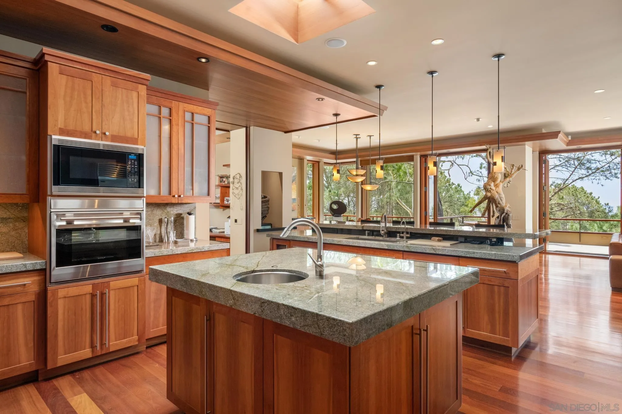 456 Hidden Pines Lane Del Mar, CA 92014 - Photo 12 of 55 a kitchen with a stove a sink and a microwave