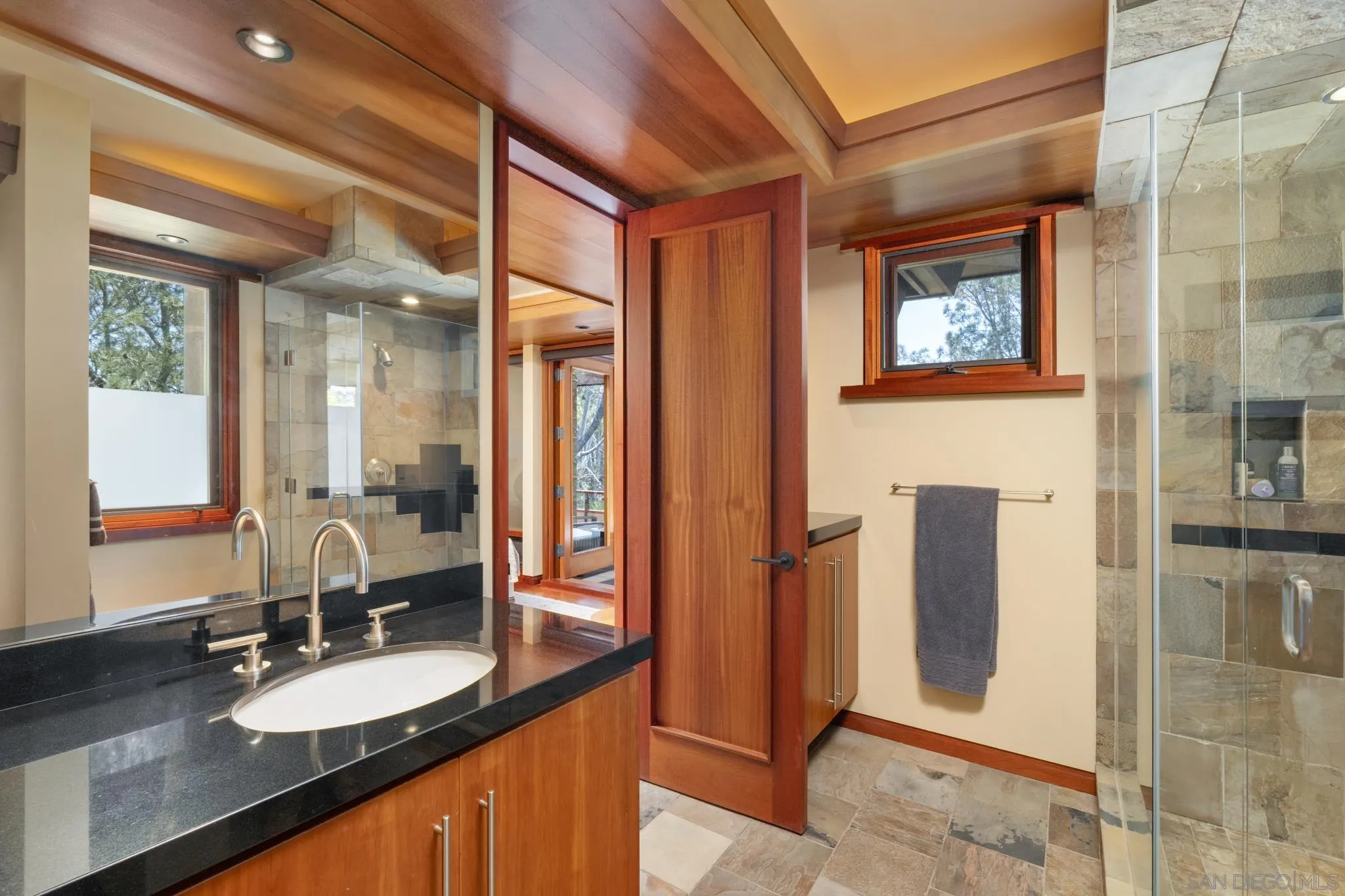 456 Hidden Pines Lane Del Mar, CA 92014 - Photo 34 of 55 a bathroom with a granite countertop sink and a mirror
