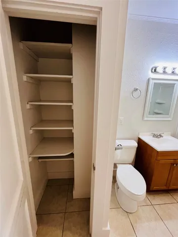 a white toilet sitting next to a bathroom sink