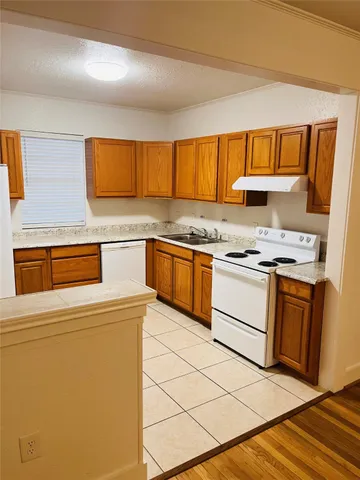 a kitchen with a stove a sink and a refrigerator