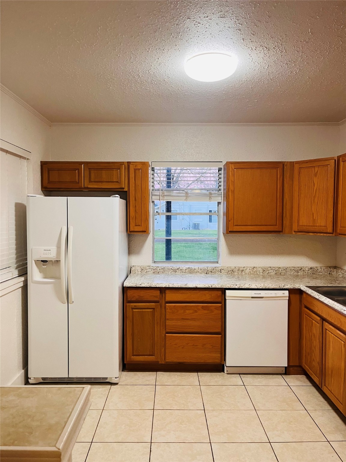 1583 Dover Street, Unit 7 Boling, TX 77420 - Photo 8 of 19 a kitchen with stainless steel appliances granite countertop a sink and a refrigerator