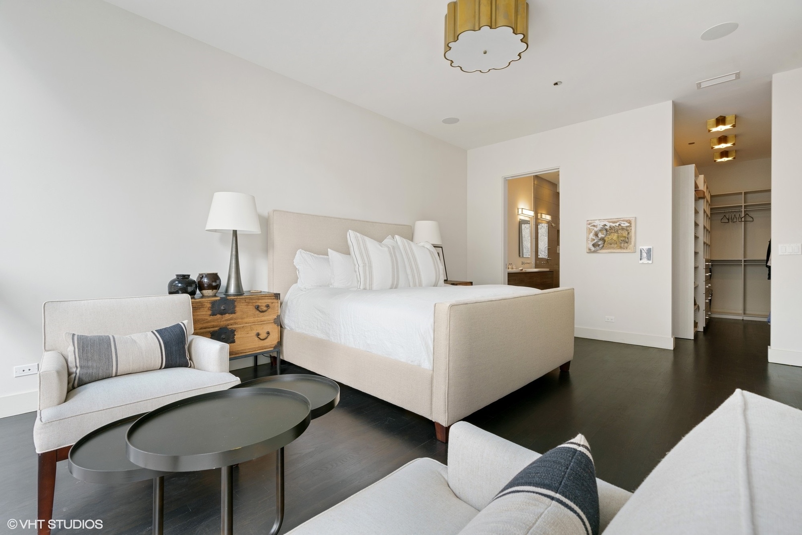747 North Clark Street, Unit 201 Chicago, IL 60654 - Photo 17 of 30 a bedroom with a bed and a chandelier