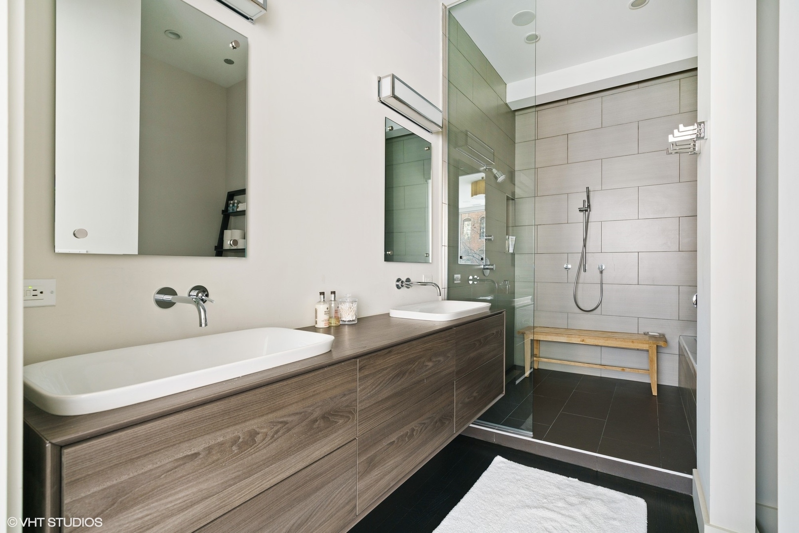 747 North Clark Street, Unit 201 Chicago, IL 60654 - Photo 19 of 30 a bathroom with a double vanity sink a toilet and a mirror