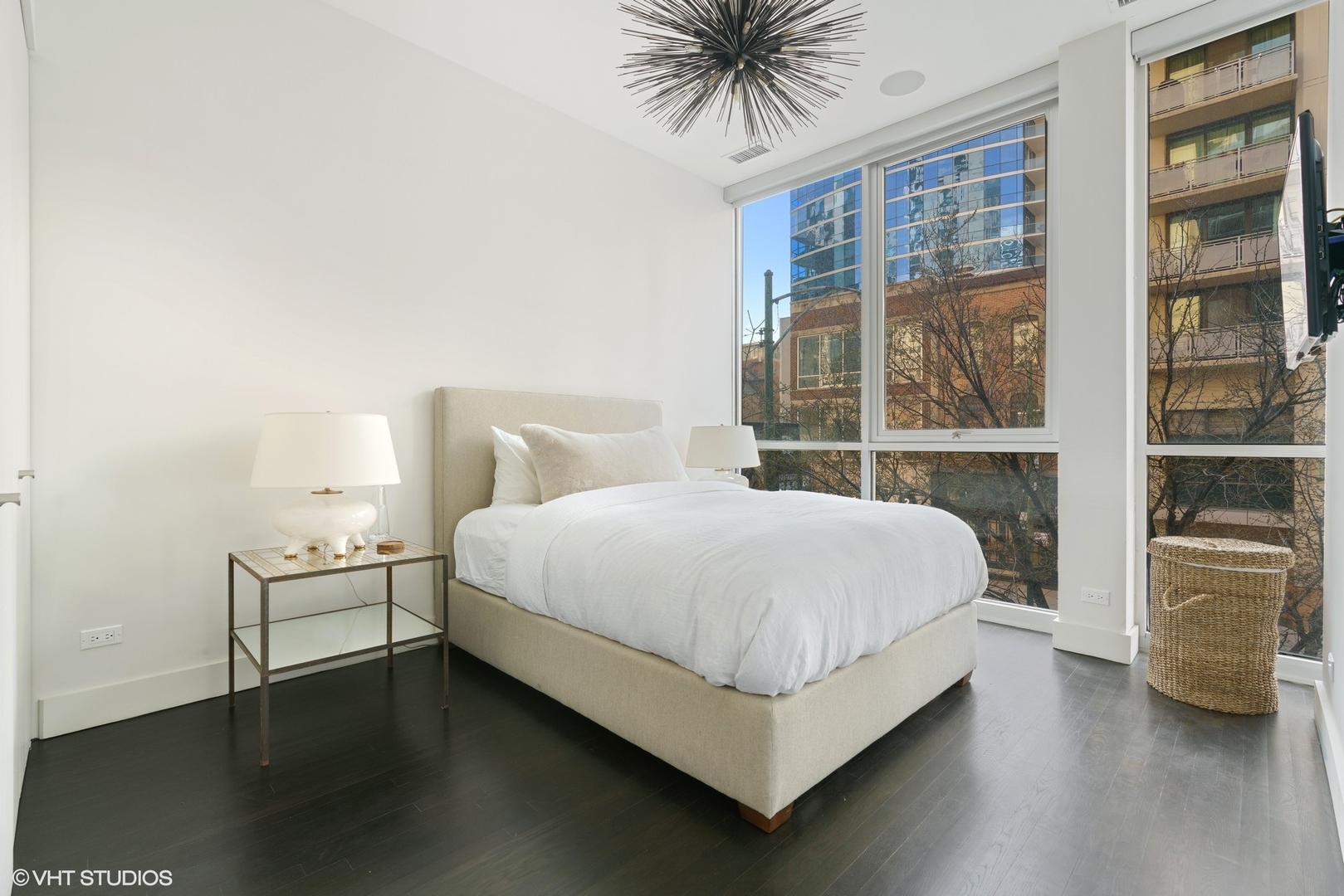 747 North Clark Street, Unit 201 Chicago, IL 60654 - Photo 22 of 30 a bed sitting in a bedroom next to a large window