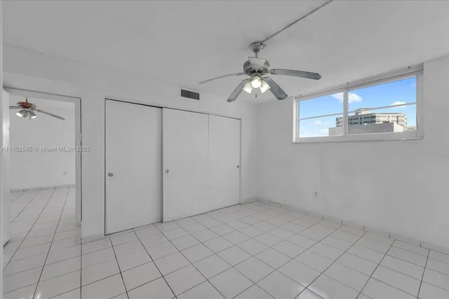 a view of a livingroom with an empty space and a ceiling fan