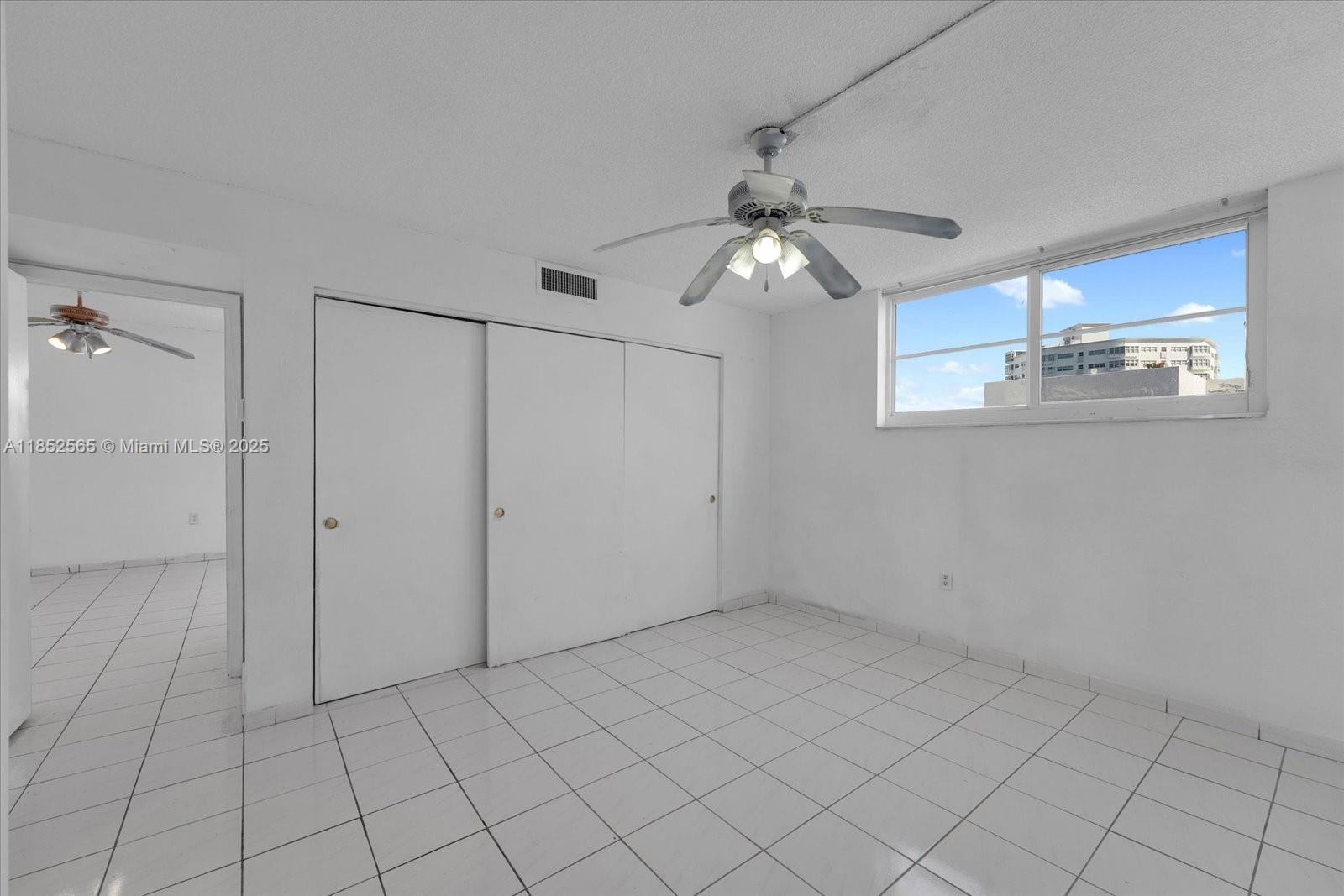 1750 James Avenue, Unit 7L Miami Beach, FL 33139 - Photo 12 of 27 a view of a livingroom with an empty space and a ceiling fan
