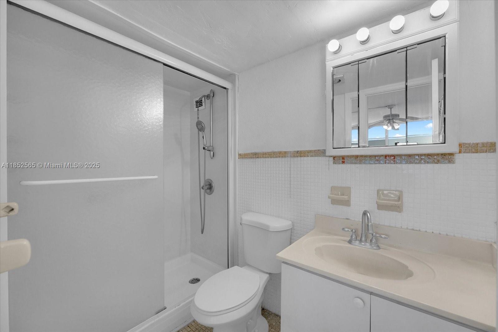 1750 James Avenue, Unit 7L Miami Beach, FL 33139 - Photo 13 of 27 a bathroom with a sink a toilet and shower