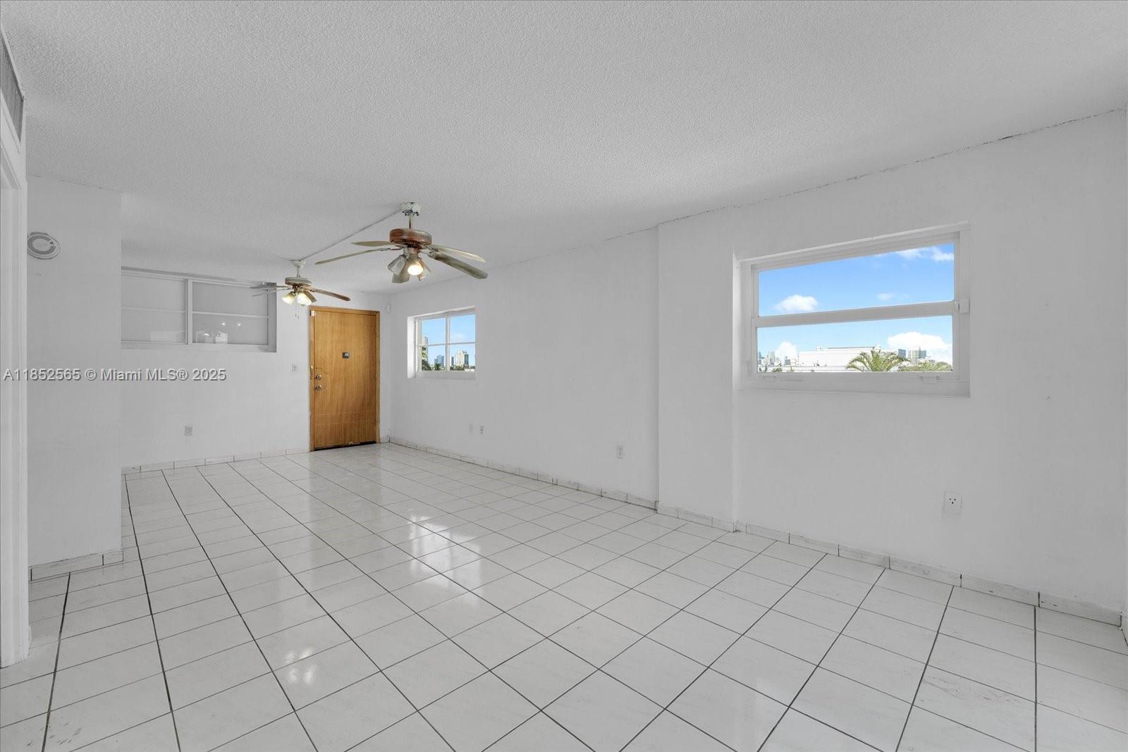 1750 James Avenue, Unit 7L Miami Beach, FL 33139 - Photo 4 of 27 an empty room with windows
